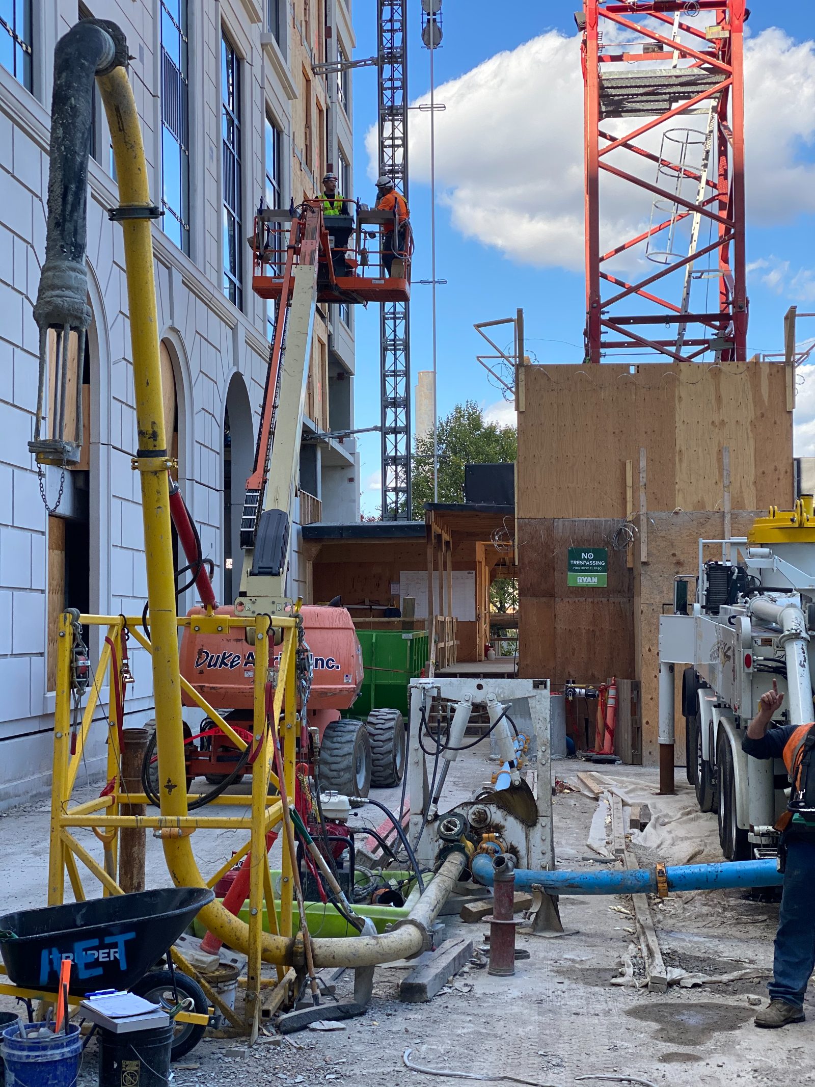 Street-side high-rise pour with pumping equipment staged at the base of the building